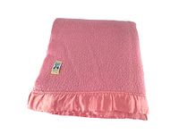 Pink wool blanket folded showing the satin trim and the Kenwood label sewn on one corner.