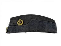 Side view of full dark gray wool wedge cap with brass RCAF badge on front and strap folded up with two brass buttons.