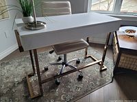 Desk angled front view showing white surface and gold legs