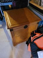 Closed brown wooden storage chest with highlighted details on the lid and latch