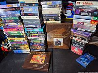 Full view of a large collection of assorted VHS tapes stacked and grouped, displaying a variety of titles and genres, with original cases in mostly good condition.