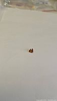 Full view of heart-shaped sapphire on a plain white background showing color and cut.