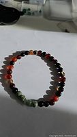 Overall view of the dream agate bracelet with visible cluster of green tree agate beads.