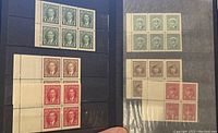 Photo showing panes of 6 green King George VI stamps, and brown and red King George VI and Edward VIII stamps