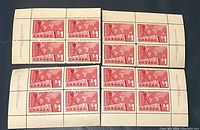 Blocks of four Canada $1 red postage stamps, Scott #411, with clear plate number markings and sheet margins intact.