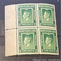 Front view of a block of four Newfoundland 2 cent postage stamps showing King George profile in apple green color error. Unique left margin with guide line visible.