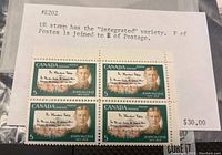 Front view of block of four 5 cent Canadian postage stamps featuring John McCrae with note about integrated variety printing error on upper right stamp