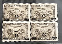 Front side of a block of four 6 Cents Air Overprint Canadian postage stamps in sepia and black ink.
