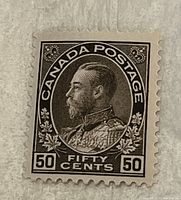 Front view of the 1898 50 cent Canada postage stamp featuring King George V in black ink with perforated edges.