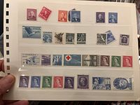 Page holding several Canadian postage stamps featuring wildlife, leaders, and symbols.