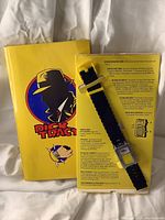 Yellow Dick Tracy branded box with the watch attached and operating instructions visible.