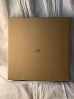 Top view of the plain light brown cardboard box with GX Display logo.