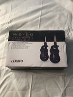 Sealed exterior box of Lekato WS-50 Wireless Guitar System showing branding and product info.