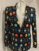 Front view of black winter blazer with colorful Pac-Man and snowflake pattern on a white mannequin.