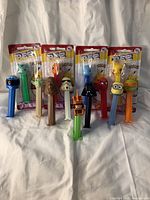 Front view of the PEZ dispensers, showing a mix of loose and packaged items with recognizable character heads from Pokémon and Star Wars franchises.