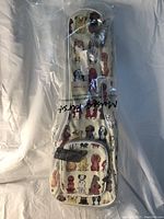 Top view of sling violin bag showing full length with dog pattern design and front zippered pocket.