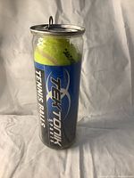 Front view of the sealed TekTonik tennis balls pack showing brand and labels on the plastic container.