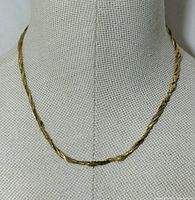 Full view of 10K gold twisted weave chain necklace displayed on mannequin bust
