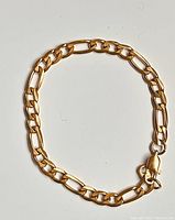 Full view of the 18k gold plated necklace chain with alternating oval and elongated links and lobster clasp.