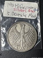 1951 German silver 5 Deutsche Mark coin in a plastic pouch with a label showing silver content and year.