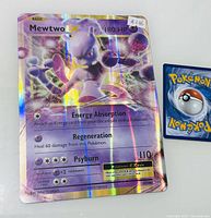 Close-up front photo of 2016 Pokemon XY Evolutions Mewtwo EX holographic card with 180 HP, card number 52/108, showing holographic sheen and condition.