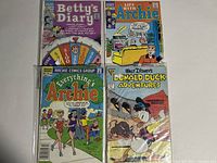 Photo showing four comic books: Betty's Diary No. 4, Life with Archie No. 282, Everything's Archie No. 261, and Walt Disney's Donald Duck Adventures No. 3.