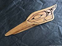 Front of wooden carved plaque showing the Raven design.