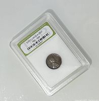 Front view of the encapsulated Lincoln Cent coin with label showing International Numismatic Bureau grading for early Lincoln Cent 1920-1929.