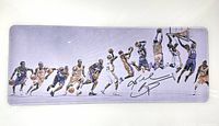 Top-down photo of the large extended gaming mouse pad featuring multiple action shots of Kobe Bryant and his printed autograph on a light background.