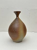 Front view of bulbous-bodied Bizen ware sake bottle with narrow neck and flared mouth