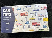 Box packaging with colorful vehicle illustrations and age indication (3+).