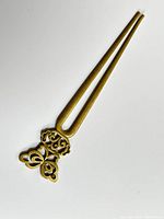 Photo of the full hair stick showing the double prong bronze shaft with a decorative butterfly shaped top piece.