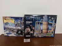 Front view of both boxes: Harry Potter Wizard Chess game and Hogwarts Great Hall 3D puzzle box with 850 pieces.
