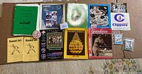 Overview of all baseball memorabilia items including magazines, pamphlets, a Yankees pin, and baseball cards.