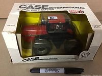 Front view of the boxed tractor showing the diecast tractor inside and the box's window display.