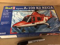 Front box view showing sealed Revell Agusta A-109 K2 REGA model kit in 1:72 scale with detailed artwork and product info.