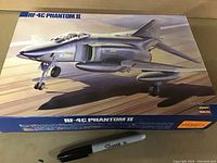 Top view of the box showing the RF-4C Phantom II aircraft artwork with a Sharpie pen for scale.