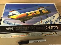 Photo of the box cover showing the illustrated Boeing Vertol KV-107 II-5 Shirasagi helicopter in flight with snowy mountain background. Box indicates model is 1:72 scale and branded by Boeing Vertol.