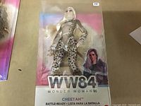 Front view of the doll in the original Wonder Woman 1984 packaging showing the full doll and box details.