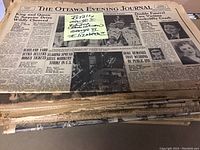 Stack of mostly complete newspapers with headlines about King George VI and Queen Elizabeth II's coronation and other royal events.