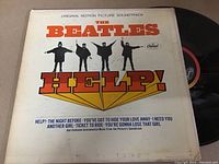 Front cover of The Beatles HELP! album showing the iconic band photo and album title in bold letters.