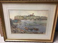 Framed watercolor painting of an East Coast harbor scene with boats and buildings, 21x17 inches.