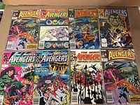 Overview of all 8 Avengers comics laid out flat showing colorful, detailed covers