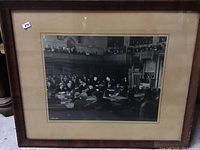 Framed black and white photo of a parliamentary session with men seated and observing in the gallery, showing overall condition and framing.