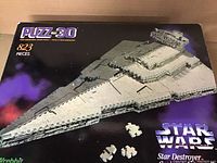 Closed box showing the front with image of completed Star Wars Star Destroyer puzzle model, 823 pieces.