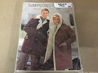 Front cover of the Simpsons-Sears 1962 Fall and Winter Catalog showing a man and woman dressed in winter coats.