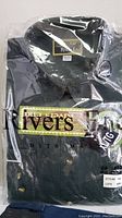 Photo of Rivers End black men's shirt folded and packaged in plastic showing size XL/LG and brand tag