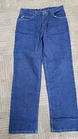 Full front view of jeans laid flat
