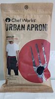 Front view of apron in original packaging showing Chef Works Urban Apron logo and packaging design.