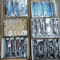 Top-down view of six cardboard boxes containing 60 individually packaged new TIMEX Vision optical eyewear frames. Frames are arranged by model in their boxes alongside branded hard cases.